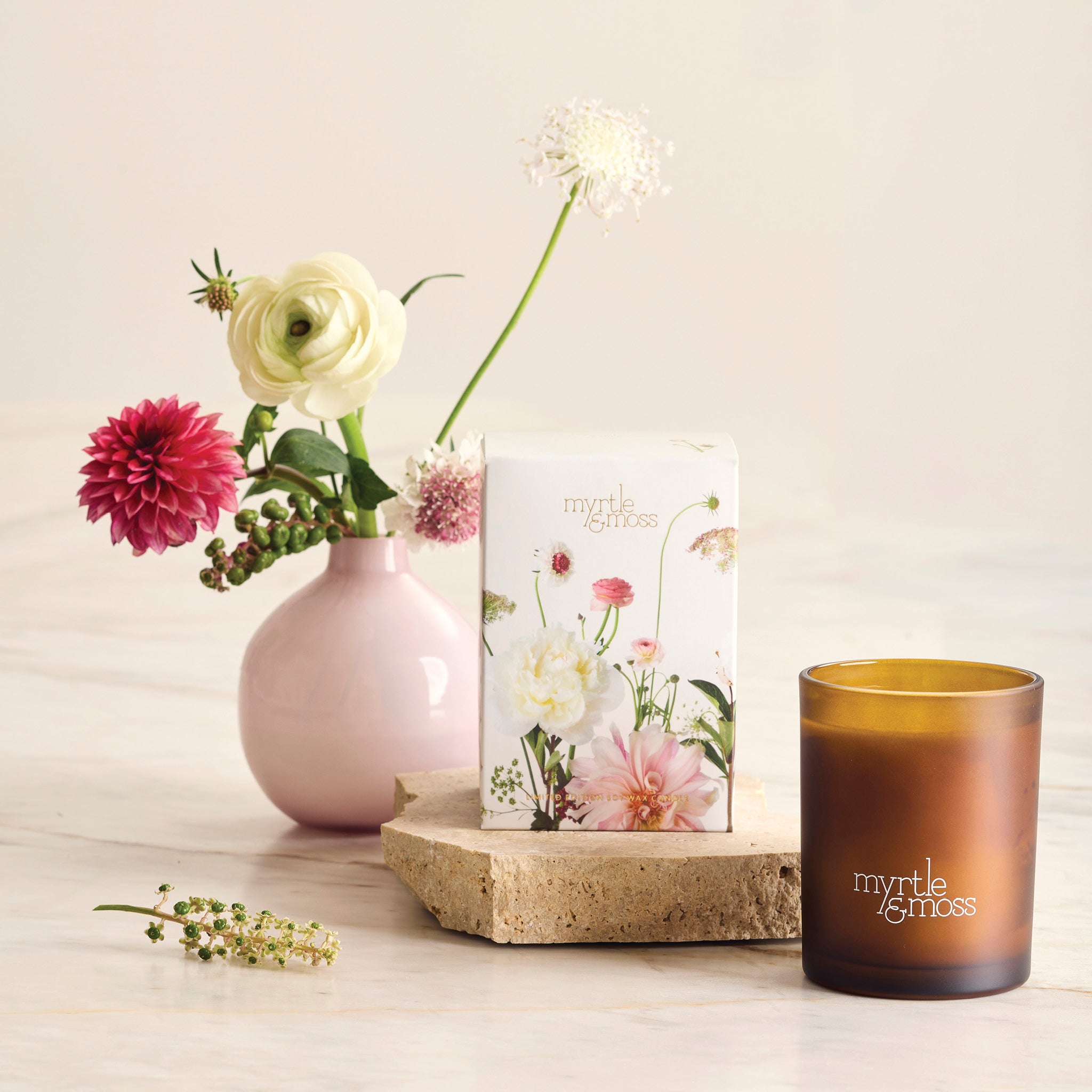 Myrtle and Moss Garden Whimsy candle styled with spring flowers